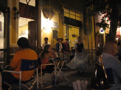 A few performers gather outside the pe&ntilde;a.